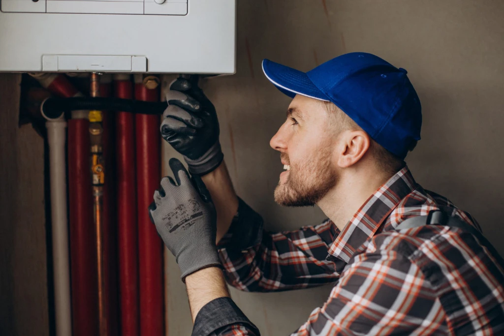 service-man-adjusting-house-heating-system.jpg service-man-adjusting-house-heating-system.jpg